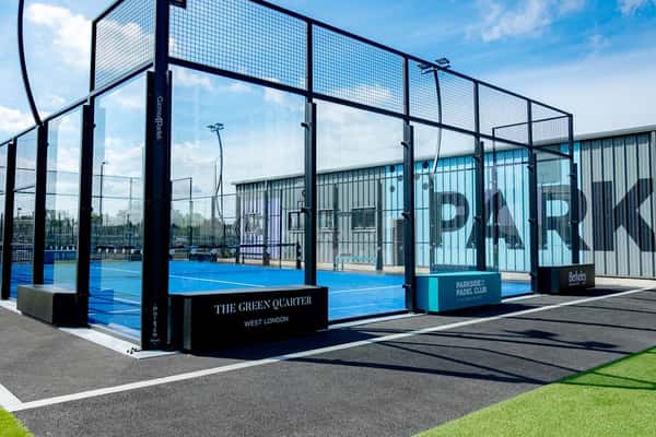 Outdoor padel tennis court at Parkside, West London, part of Active Away's clinic with glass enclosures and modern amenities.