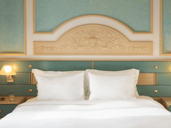 Royal Mare Double-Twin Bungalow with two twin beds, elegant teal and beige interior, and views of a manicured garden.