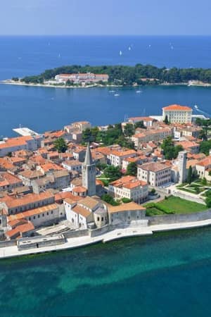 Aerial view of Poreč, Croatia, highlighting medieval architecture, the Euphrasian Basilica, and the surrounding Adriatic Sea.