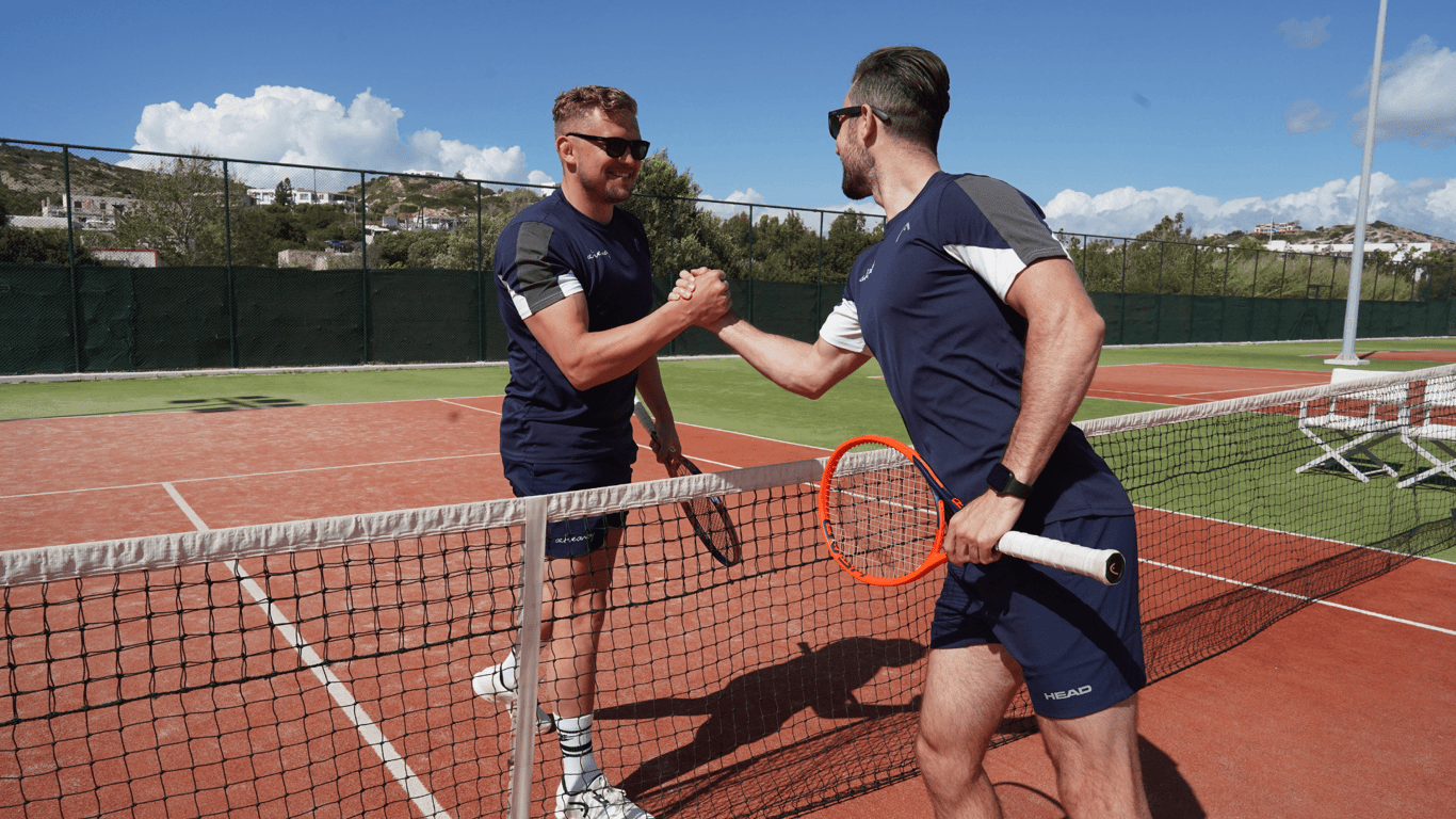 tennis management image - coaches shaking hands over the tennis net.png