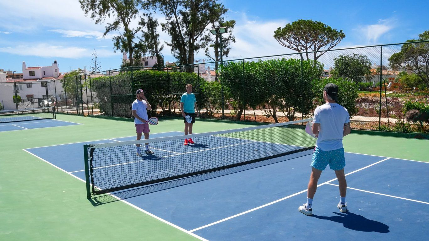 Pickleball players on an outdoor court at the hotel