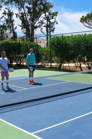 Pickleball players on an outdoor court at the hotel