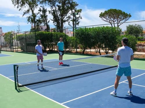 Pickleball players on an outdoor court at the hotel