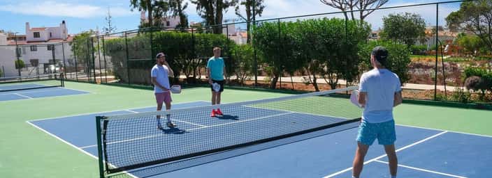 Pickleball players on an outdoor court at the hotel
