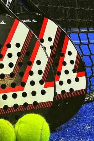 Padel rackets and balls beside the net at Advantage Padel Nottingham