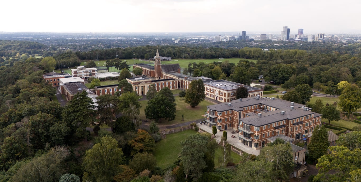 Aerial view of the Royal Russell campus with buildings, sports fields and trees near London.