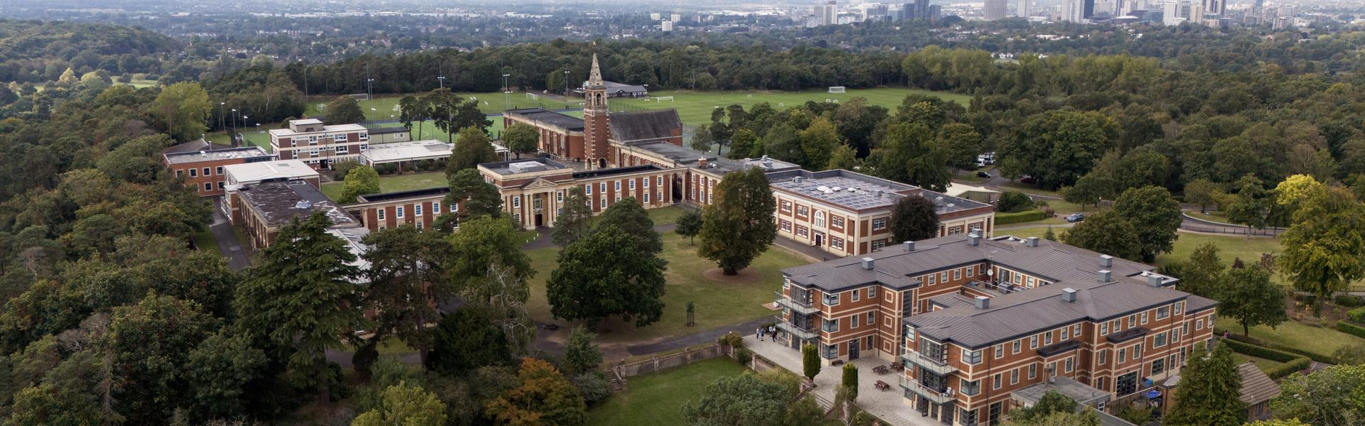 Aerial view of the Royal Russell campus with buildings, sports fields and trees near London.