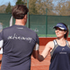 Two tennis players in Active Away kit shake hands on a clay court.